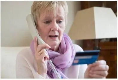 Woman providing credit card details over the phone