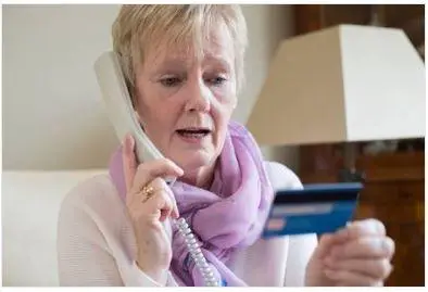 Woman providing credit card details over the phone