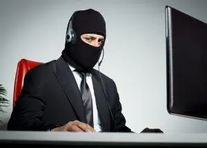 Anonymous man with mask using computer